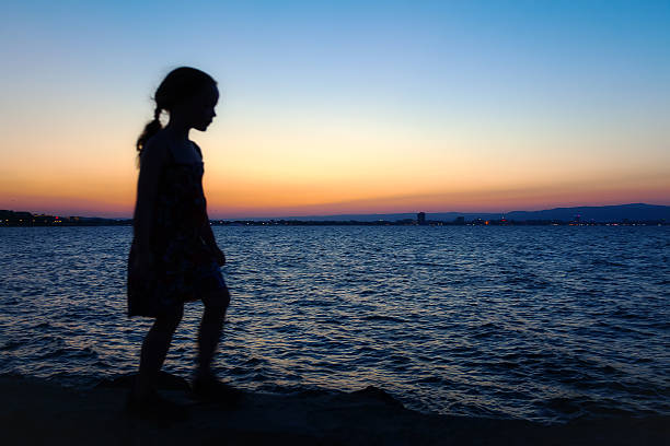 Silhouette Of A Girl Standing Sideways Stock Photos, Pictures & Royalty ...