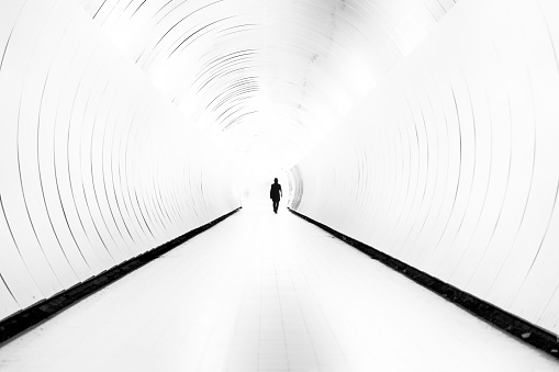 Silhouette Of Man Walking In Bright Tunnel Stock Photo - Download Image ... Silhouette Man Walking Tunnel
