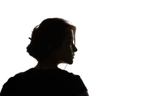 Silhouette of pensive woman looking away isolated on white Silhouette of pensive woman looking away isolated on white back lit photos stock pictures, royalty-free photos & images