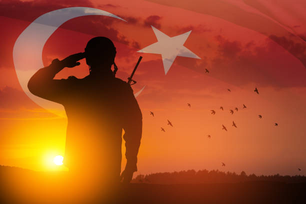 Silhouette of soldier on a background of Turkey flag and the sunset or the sunrise. stock photo