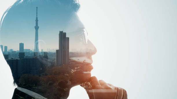 Silhouette of thinking man and modern cityscape. Double exposure. stock photo