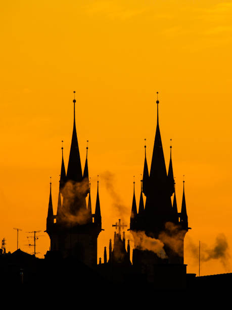 Silhouette of two towers of Church of Our Lady before Tyn in morning Prague, Czech Republic. Contrast black controur and orange sky Silhouette of two towers of Church of Our Lady before Tyn in morning Prague, Czech Republic. Contrast black controur and orange sky. prague art stock pictures, royalty-free photos & images
