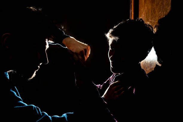 silhouette of two young guys in the dark place bully and fight conception silhouette of two young guys in the dark place bully and fight concept gang stock pictures, royalty-free photos & images