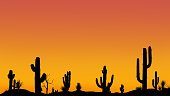 istock Silhouettes of different cacti at sunset with a cloudless sky in the desert. Desert sunset with clear sky without clouds. 1322890913