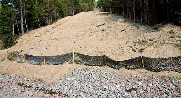 Silt fence Silt fence used for sediment control plus rip rap used for erosion control. erosion control stock pictures, royalty-free photos & images
