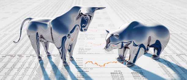 Silver Bull and Bear on Newspaper Silver Bull and Bear standing on a financial Newspaper with Charts STOCK mARKET  stock pictures, royalty-free photos & images