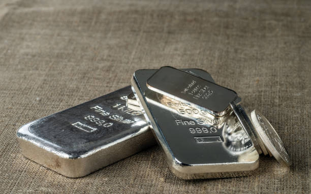 Silver bullion. Cast and minted silver bars and coins stock photo