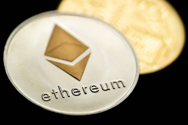 Silver Ethereum cryptocurrency coin Close up shot of a silver Ethereum digital cryptocurrency coin, front and back.  With Ethereum  stock pictures, royalty-free photos & images