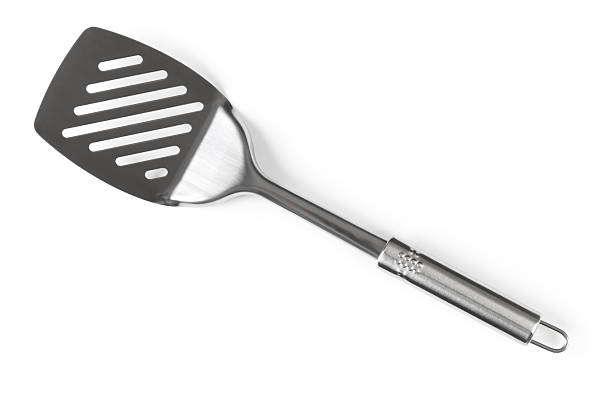A silver spatula angled diagonally  stock photo