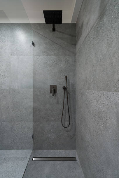 Simple and elegant shower in granite tiles stock photo