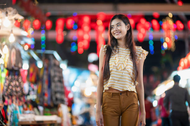 Simple Girl Portrait of a beautiful asian girl walking through the Chinatown market of Kuala Lumpur. chinatown kuala lampur stock pictures, royalty-free photos & images