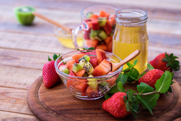 Simple strawberry and kiwi Fruit salad with honey stock photo