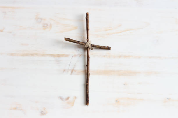 Simple wood cross centred on white  good friday stock pictures, royalty-free photos & images