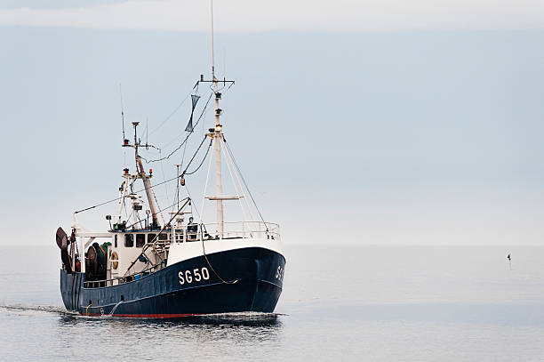 Simrishamn, Sweden: Trawler returning to port stock photo