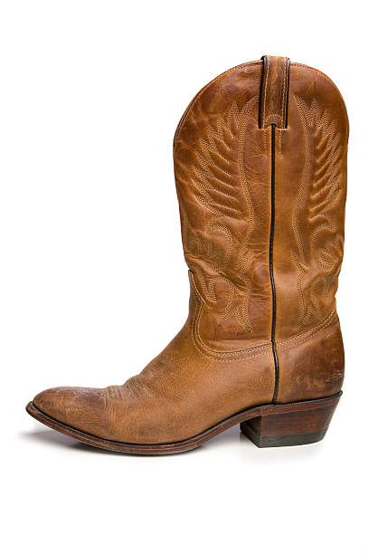 Single brown cowboy boot in side view Single cowboy boot with slight shadow and reflection cowboy boot stock pictures, royalty-free photos & images