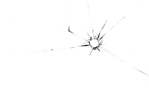 A single bullet whole through glass on a white background stock photo