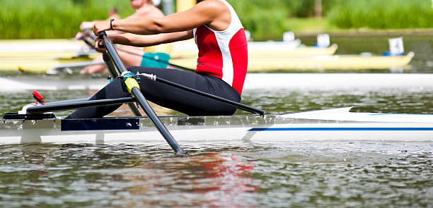 Single scull women's rowing start stock photo