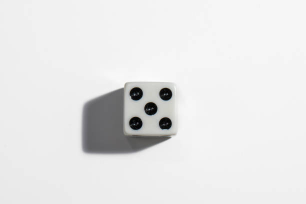 Single white dice with a five on a white background. Win or lose. Catch your luck. Gambling equipment. stock photo