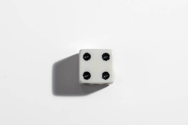 Single white dice with a four on a white background. Win or lose. Catch your luck. Gambling equipment. stock photo