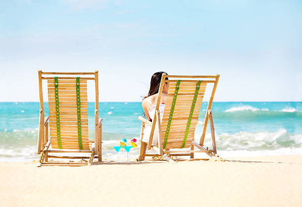 Single Woman on Beach Vacation Waiting for Partner Single woman Hoping Waiting anticipating a travel partner in beach vacation. divorce beach stock pictures, royalty-free photos & images