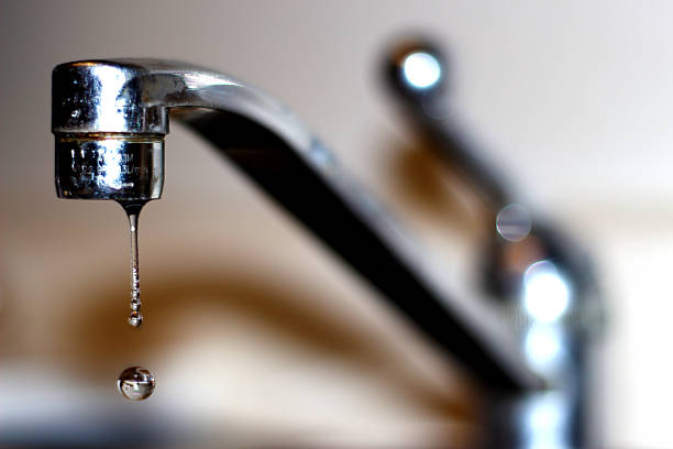 Sink Drip I high shutter speed photo of a water droplet. faucet stock pictures, royalty-free photos & images