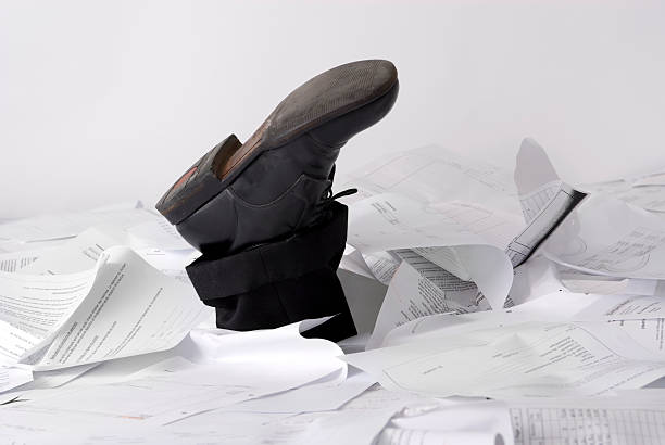 Sinking in paperwork stock photo