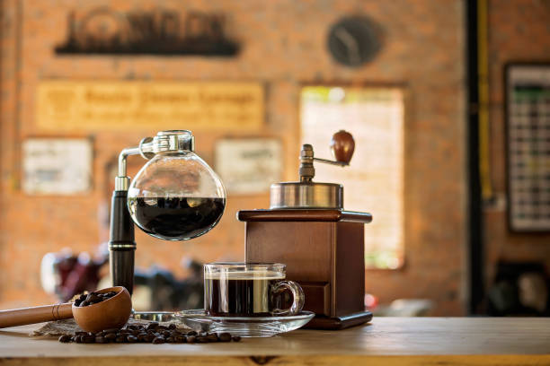 Siphon vacuum coffee maker on cafe bar Siphon vacuum coffee maker on cafe bar siphon stock pictures, royalty-free photos & images