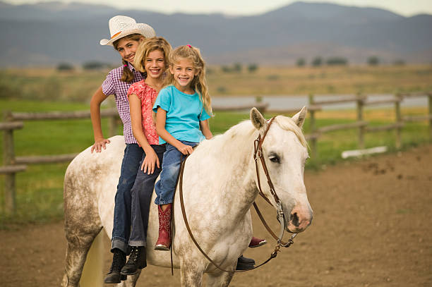 Sisters horseback riding stock photo