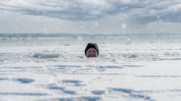 sitting in a frozen lake - ice swimming stockfoto's en -beelden
