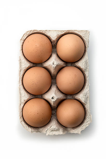 Six eggs in carton on white stock photo