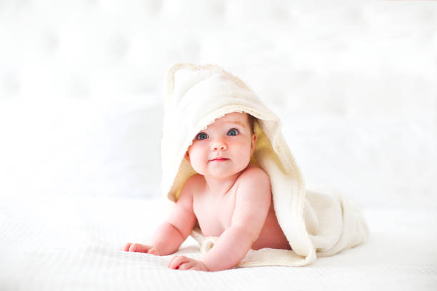 Six month baby wearing towel after bath stock photo