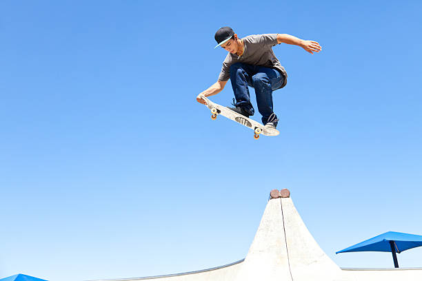 Skateboard Air Walk XXXL. Young man doing an air walk skateboard trick. gchutka stock pictures, royalty-free photos & images