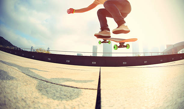 skateboarder skateboarding at  city stock photo