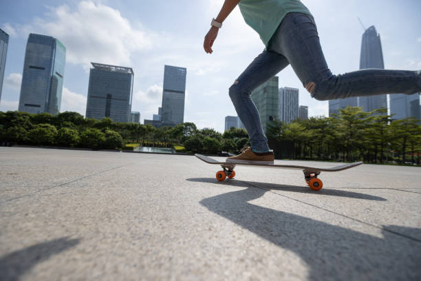 Skateboarder skateboarding outdoors in city stock photo