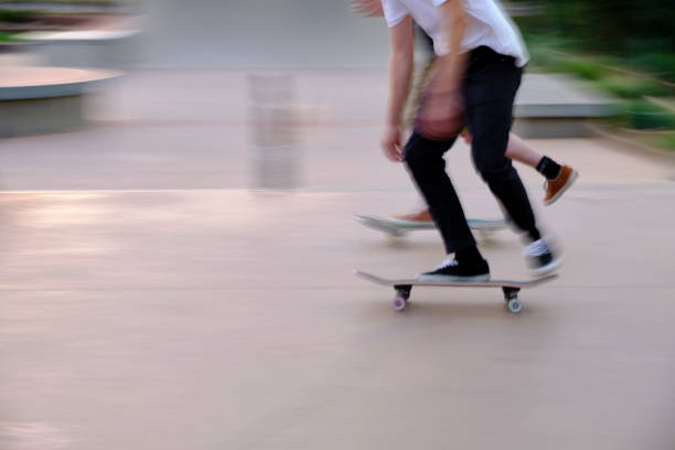 Skateboarders Practice at Skate Park -- Motion Blur stock photo