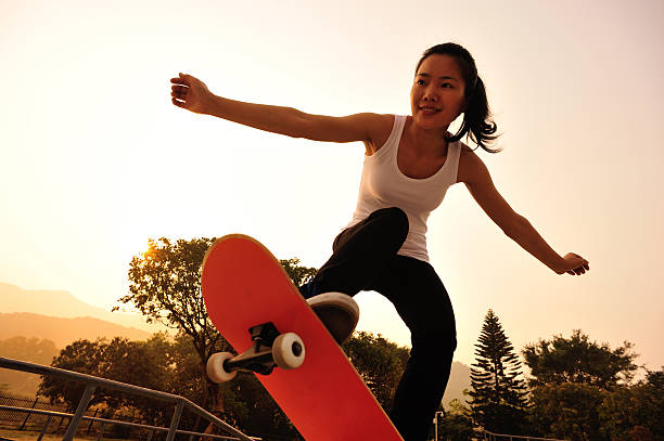 skateboarding skateboarding at sunrise park asian girls feet stock pictures, royalty-free photos & images