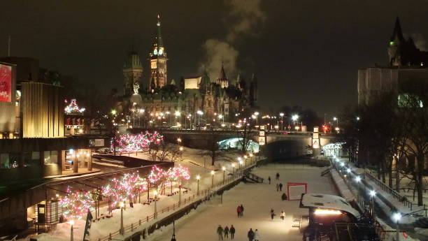 Skating on the Rideau Canal at night during Winterlude in Ottawa, Canada. stock photo