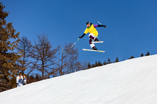 Sakhalin Island, Russia - March 26, 2011: Ski freeride skier performs jump elements during the local contest on the hill in Sakhalin Island.
