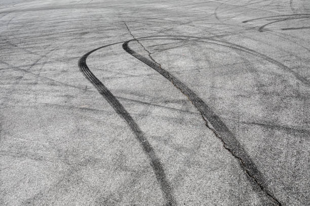 Skid marks tire marks on motor race track asphalt international circuit Skid marks tire marks on motor race track asphalt international circuit.shoot down view. skid mark stock pictures, royalty-free photos & images