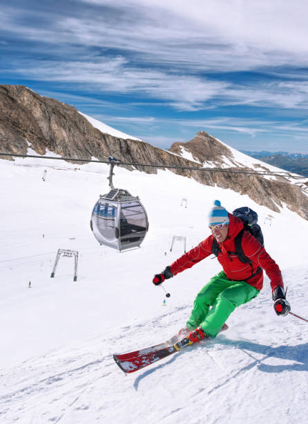 Skier skiing downhill during sunny day in high mountains, Kaprun glacier- Zell am see, Austria stock photo
