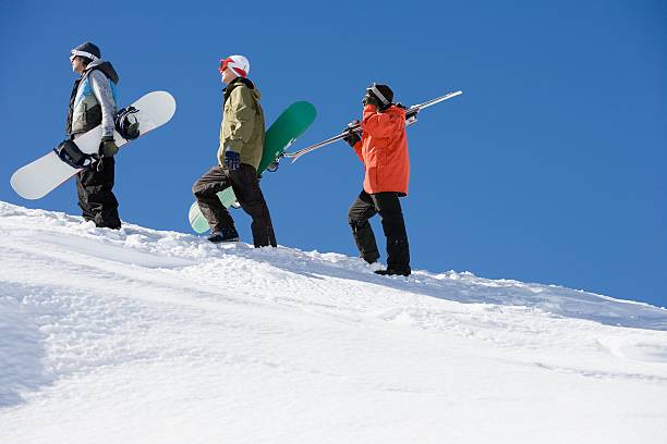 skiers and snowboarders going up mountain - skidled bildbanksfoton och bilder