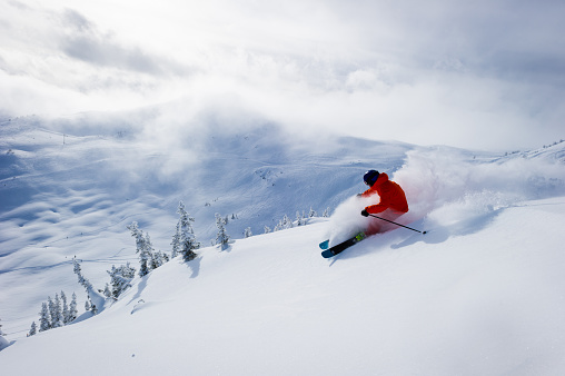 Male skiing fresh powder in the mountains. North America's best ski resorts. Canada's top ski destination.