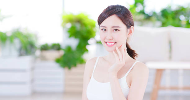 skin care asian woman Smiling asian woman enjoying the skin care and smile to you human mouth stock pictures, royalty-free photos & images