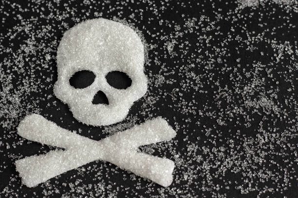 skull shape from sugar on black background, Concept Death symbol with skull shape from sugar on black background, Concept Sugar and sweet leads to diabetes. Diabetes Mellitus Killer Copy space World Diabetes Day 14 November sugar food stock pictures, royalty-free photos & images