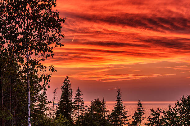 Sky on Fire This summer sunset was captured on the Lake Huron side of Tobermory, in early July. This great little summer cottage location is the perfect place for rest and relaxation, located on the Bruce Peninsula, Ontario, Canada bruce peninsula stock pictures, royalty-free photos & images