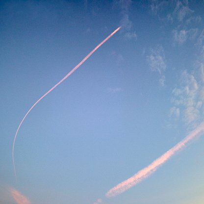 Sky with aircraft vapor trails clouds at sunset, Amsterdam, The Netherlands