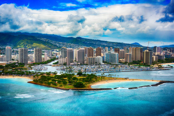 Skyline Aerial of Honolulu Hawaii The beautiful coastline Honolulu Hawaii shot from an altitude of about 500 feet during a helicopter photo flight over the Pacific Ocean. hawaii islands stock pictures, royalty-free photos & images