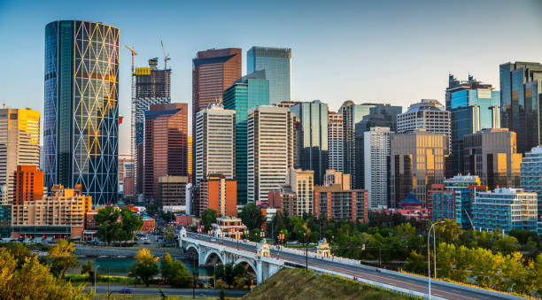 Skyline of Calgary in Canada Calgarys skyline with its skyscrapers and office buildings. Bow river and centre Street Bridge in the foreground. Alberta - Canada calgary stock pictures, royalty-free photos & images
