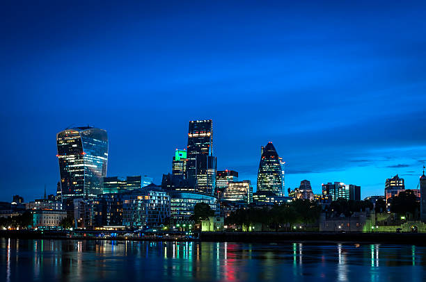 Skyline of The City in London, England at night stock photo