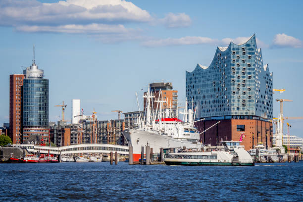 skyline of the hafencity in hamburg with view to the überseebrücke with a famous old freighter and the elbphilharmonie concert hall in the background skyline of the hafencity in hamburg with view to the überseebrücke with a famous old freighter and the elbphilharmonie concert hall in the background elbe river stock pictures, royalty-free photos & images
